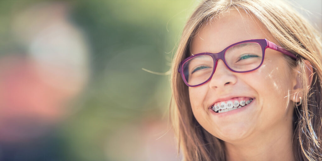 child smiling brightly while being outside