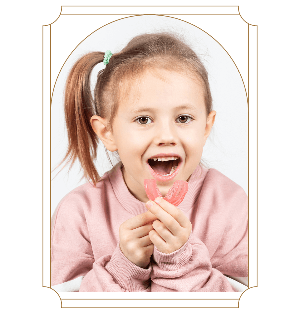 child patient putting on their mouth plate for myofunctional therapy