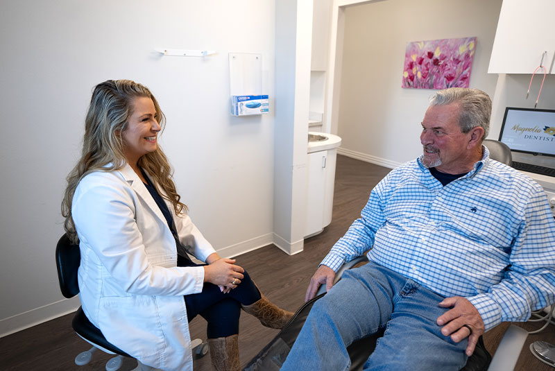 Dr. Schuster Kathleen. consulting with patient
