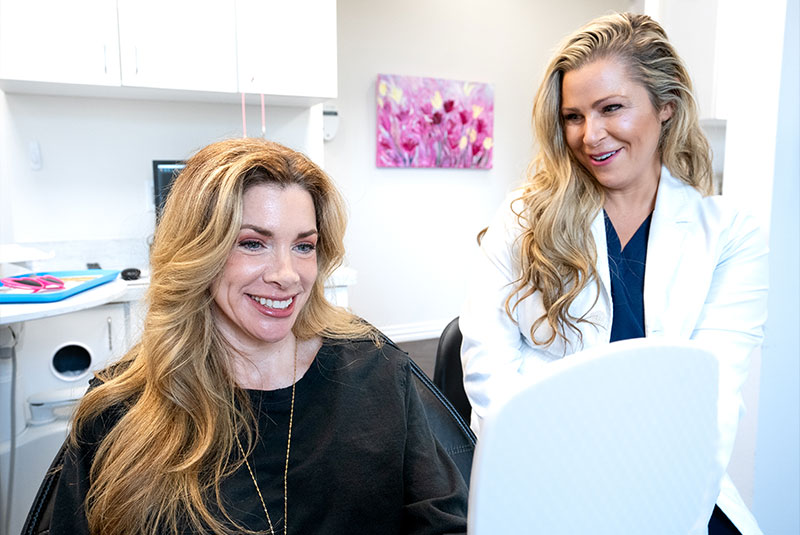 Dr. Schuster Kathleen showing patient there teeth after endodontic therapy